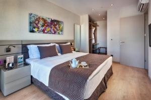 a bedroom with a large bed with a table at Fraser Place Antasya Istanbul in Istanbul
