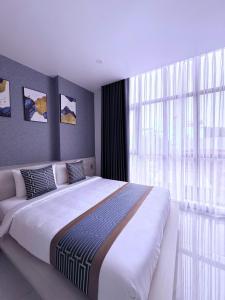 Ένα ή περισσότερα κρεβάτια σε δωμάτιο στο The Luxury