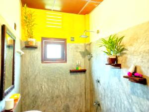 a bathroom with a shower and a toilet and a window at Coco Garden Villas 4 in Hikkaduwa