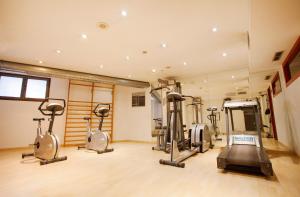 a gym with three exercise bikes in a room at Hotel Himàlaia Soldeu in Soldeu