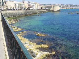 a view of a body of water with a bridge at Tolomei House Holidays Sea View in Siracusa