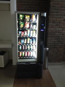 a refrigerator filled with lots of sodas and drinks at Estúdio Vila Madalena in Sao Paulo