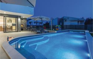 a swimming pool in the backyard of a house at Amazing Home In Biograd With Kitchen in Biograd na Moru +61 photos