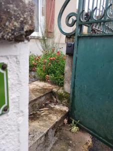 an entrance to a house with a green door at Maison de maître in Bressuire