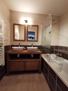 Un baño con dos lavabos, una ducha y una bañera. en Nantes RENAUDIERE - Proche Parc Expo Stade Beaujoire - Wifi - Parking - Tramway bus, en Nantes