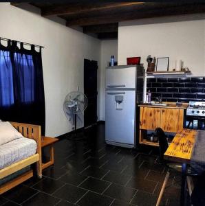 eine Küche mit einem Kühlschrank und einem Tisch im Zimmer in der Unterkunft Aguarà del Sol-Aguarà Guazù in Valle Hermoso