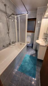 a bathroom with a tub and a toilet and a sink at B&B St Moritz in St. Moritz +25 photos