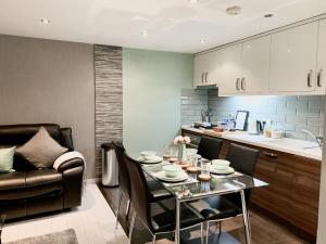 a kitchen and dining room with a table and a couch at Richmond House by Staytor in Exeter