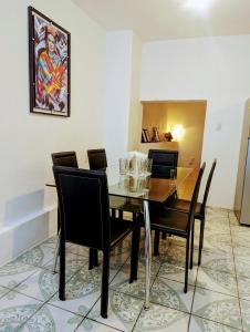 a dining room with a glass table and chairs at Casa Madrigal in Guanajuato