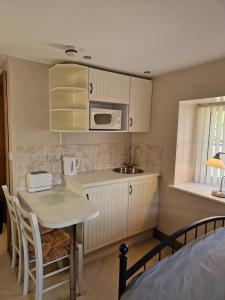a small kitchen with a table and a microwave at The Granary at High Brooms Farm in Consett +14 photos