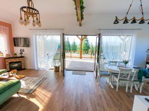 a living room with a table and a dining room at Cozy Living in Dealu Negru