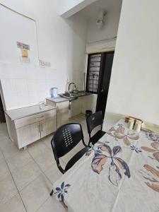 a room with a table and a chair in a kitchen at USIM, KLIA, POLI Nilai in Nilai
