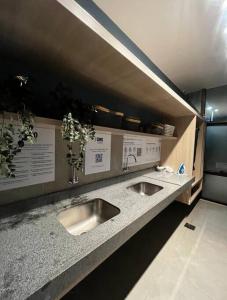 a counter with two sinks in a kitchen at Studio Orion in Rio de Janeiro