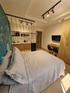 a bedroom with a large bed and a desk at Studio Orion in Rio de Janeiro +13 photos