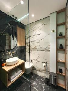 a bathroom with a shower and a sink and a toilet at Studio 7- A chic urban hideaway, 10min walk to city center in Timişoara