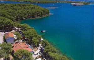 an island with a boat in a large body of water at Six-Bedroom Holiday Home In Sibenik in Šibenik