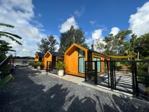 a row of cottages in a parking lot at Sea Salt Casa Bang Tao in Ban Thalat Choeng Thale