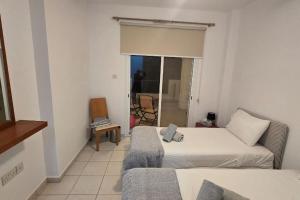 a hotel room with a bed and a couch at Hesperides gardens, spacious 2 bedroom apartment in Paphos