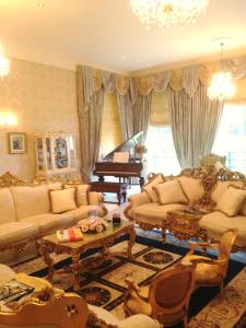 a living room filled with furniture and a piano at Rossmanagher House in Bunratty