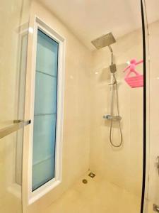 a bathroom with a shower and a window at Olympus City Garden 1 Bedroom in Pattaya South +4 photos