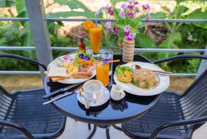 a table with plates of food and drinks on it at Modern Bungalows in Ko Chang