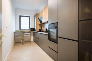 a kitchen with a stove and some stools in it at Silver SKY in Voluntari