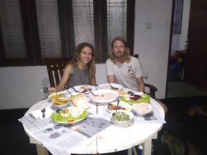 a man and woman sitting at a table with food at Jayanika Residence in Tangalle