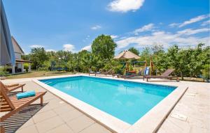a swimming pool with a swing and a playground at Three-Bedroom Holiday Home In Vinjani Gornji in Aračići +34 photos