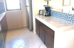 eine Küche mit Theke und Kühlschrank in der Unterkunft Spectacular Vacation Home Ocean View Walk to Beach in Cabo San Lucas + 92 Fotos