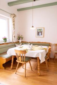 a dining room with a table and chairs at Landhaus Oberrainer in Bad Griesbach