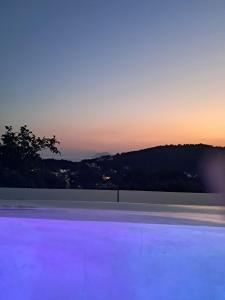 a dusk view of a tennis court at dusk at Villa George in Skiathos in Skiathos