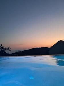 a view of a body of water at sunset at Villa George in Skiathos in Skiathos