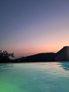 a view of a body of water at sunset at Villa George in Skiathos in Skiathos +60 photos
