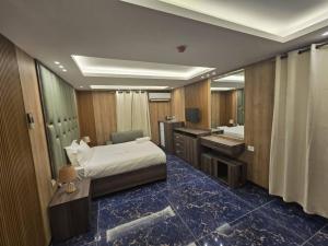 a bedroom with a bed and a bathroom with a sink at La Luna in Bangui