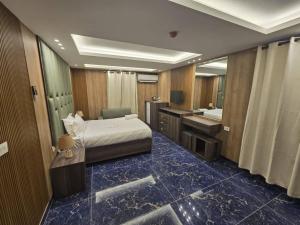 a bedroom with a bed and a bathroom with a sink at La Luna in Bangui +3 photos