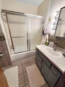 a bathroom with a sink and a shower at Unsalted Shores on Big Spirit Lake in Orleans +24 photos