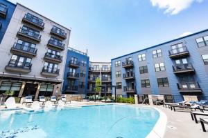 a large swimming pool in front of some buildings at Charming 1BR 1BA Apartment Near Downtown Cincinnati in Cincinnati