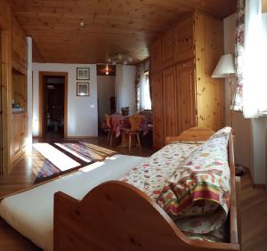 a bedroom with a bed and a dining room at Supermountainski Colfosco in Colfosco