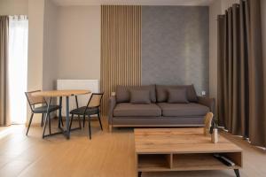a living room with a couch and a table at Luxury Central Apartment 4,2 in Larisa