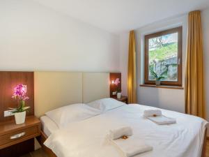a bedroom with two white beds and a window at Apartment Emma-3 by Interhome in Dürnberg
