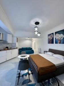 a bedroom with a large bed and a blue couch at Romantic Solid Lamera Residence in Mamaia