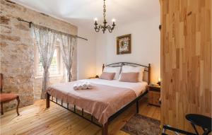 a bedroom with a large bed with a chandelier at Four-Bedroom Holiday Home In Kringa in Kringa