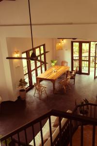 a dining room with a wooden table and chairs at Slow Life Boutique Hotel - Adults Only in Mirissa