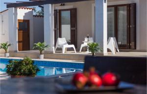 a plate of fruit on a table next to a pool at Villa Bonasera in Šišan