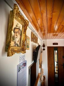 a painting of a man hanging on a wall at Domek KALINKA -Góry Sowie-Rzeczka in Rzeczka +35 photos