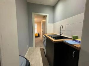 a small kitchen with a sink and a stove at City Rd C - Central Location Long Stay by ShortStayUK in Bristol