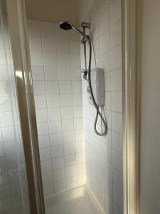 a shower with a shower head in a bathroom at Sunset Hideaway, Bridlington in Bridlington +28 photos