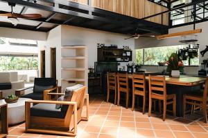 a kitchen and living room with a table and chairs at Tumbo Resort in Cabo Matapalo