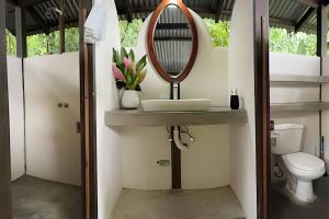 a bathroom with a sink and a mirror at Tumbo de las Olas in Cabo Matapalo