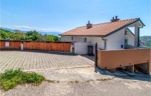 a white house with a fence and a brick driveway at Beautiful Apartment In Bribir With Wifi in Bribir